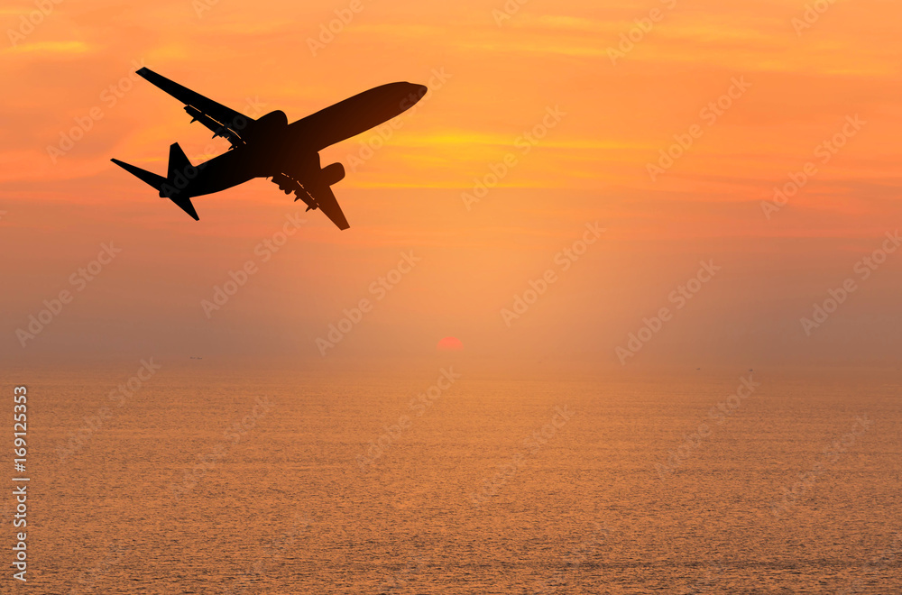 Silhouette passenger airplane flying away in to sky high altitude  during sunset