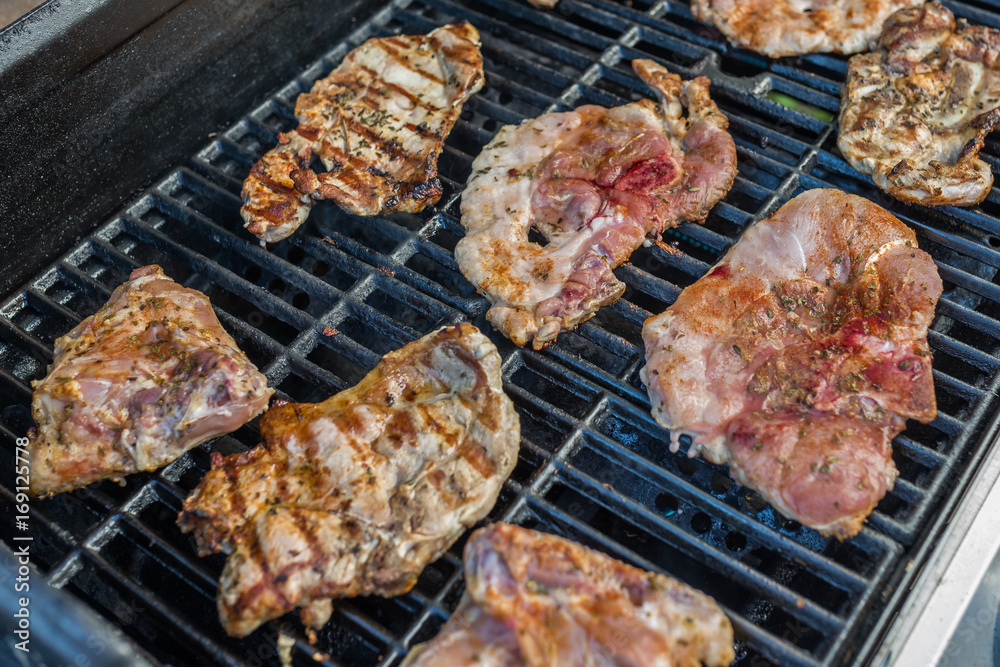  Delicious pork steaks on the grill 
