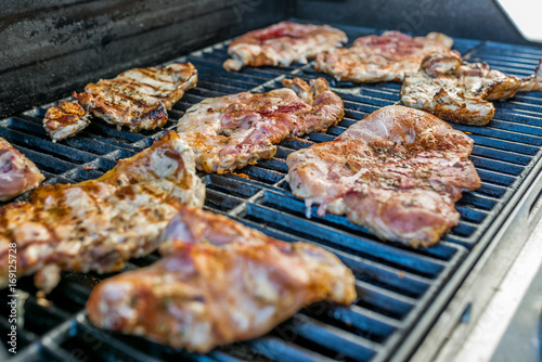  Delicious pork steaks on the grill 
