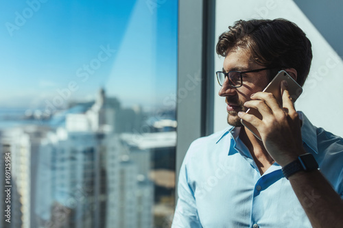 Closeup of a business investor talking on phone. photo