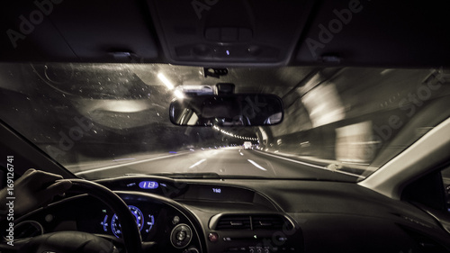 Cockpit view driving car inside a dark tunnel © jordieasy