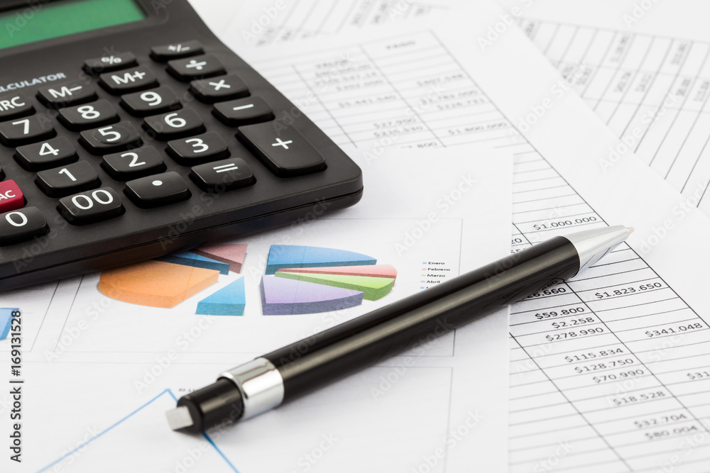 Monthly budget spreadsheet, pen and calculator Monthly budget spreadsheet, pen and calculator