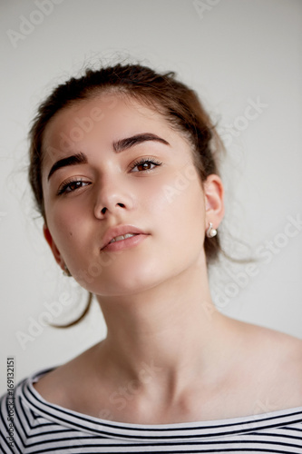 Portrait of young beautiful girl with brown eyes and black hair.Natural beauty  with clean glowing skin.