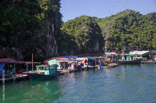 traditional vietnamese boats and floating village among beautiful limestone rocks of Lan Ha bay, the southern edge of Ha Long bay, Vietnam