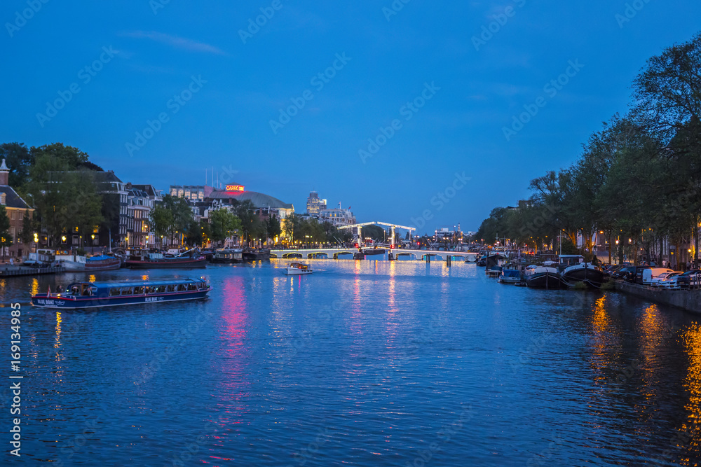 Evening view over famous Amstel River in the city of Amsterdam