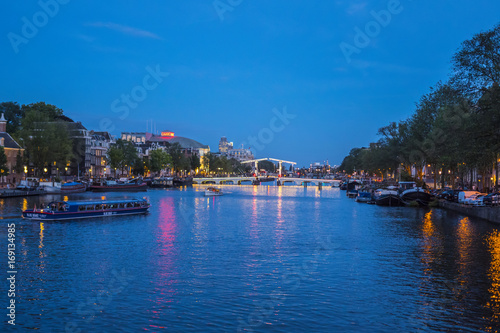 Evening view over famous Amstel River in the city of Amsterdam