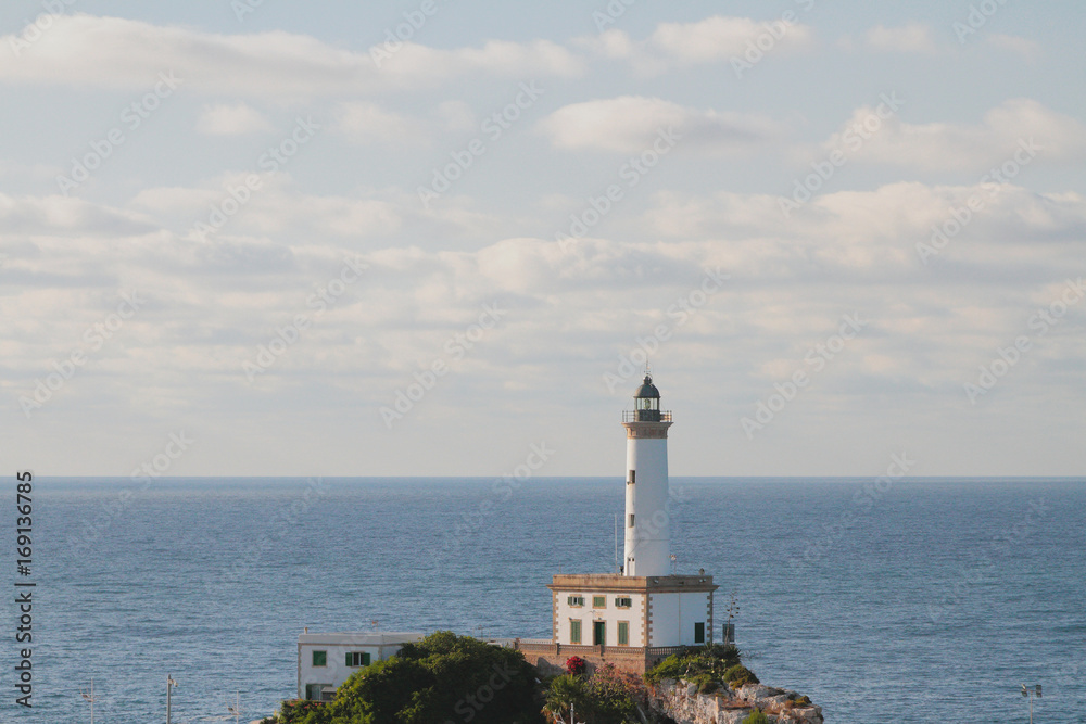 Beacon on rock and sea. Ibiza, Spain