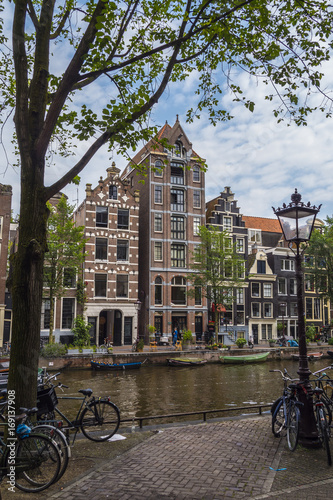 The amazing small houses at the canals in the city center of Amsterdam - AMSTERDAM - THE NETHERLANDS - JULY 20, 2017