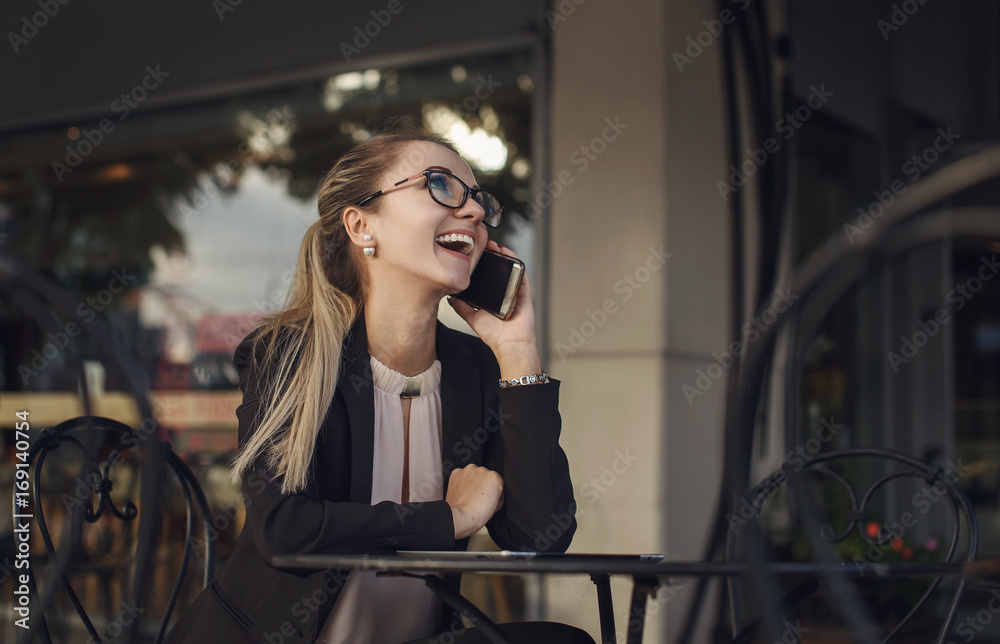 Young business woman laughing on the phone Young business woman laughing on the phone
