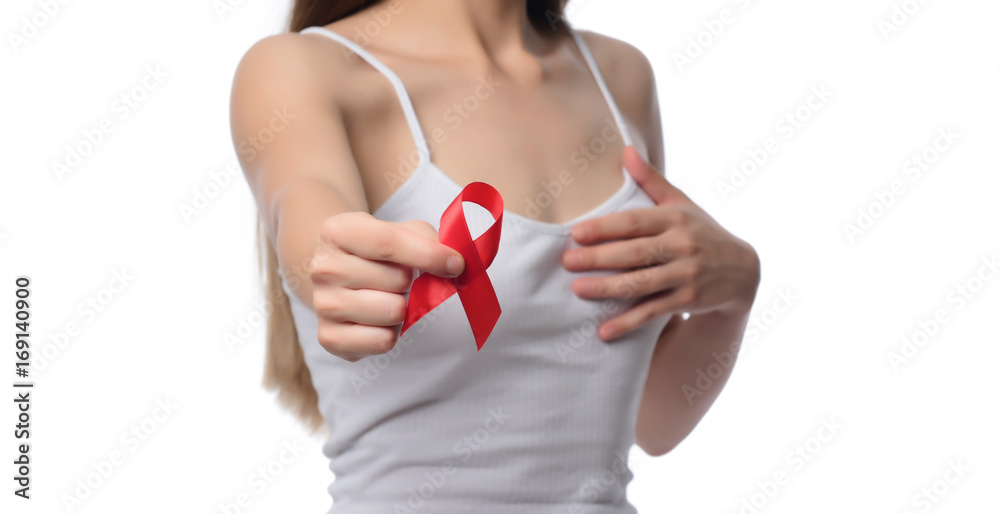 Healthcare and medicine concept - woman holding red AIDS HIV awareness ribbon Healthcare and medicine concept - woman holding red AIDS HIV awareness ribbon