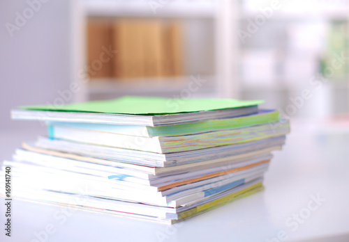 close up of stack of papers on white background