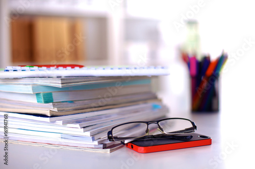 close up of stack of papers on white background