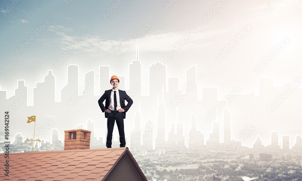 Engineer man standing on roof and looking away. Mixed media Engineer man standing on roof and looking away. Mixed media