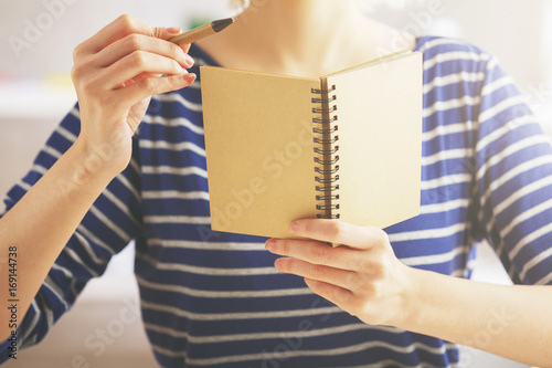 Female showing empty notepad photo