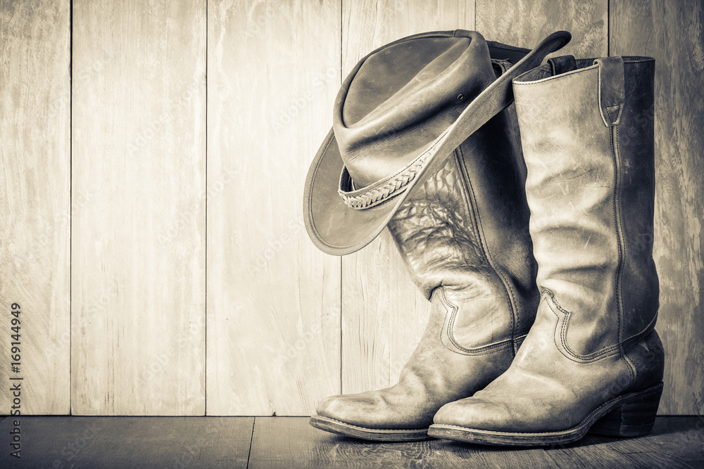 Wild West cowboy hat old boots. Vintage style sepia photo Stock-foto | Adobe Stock