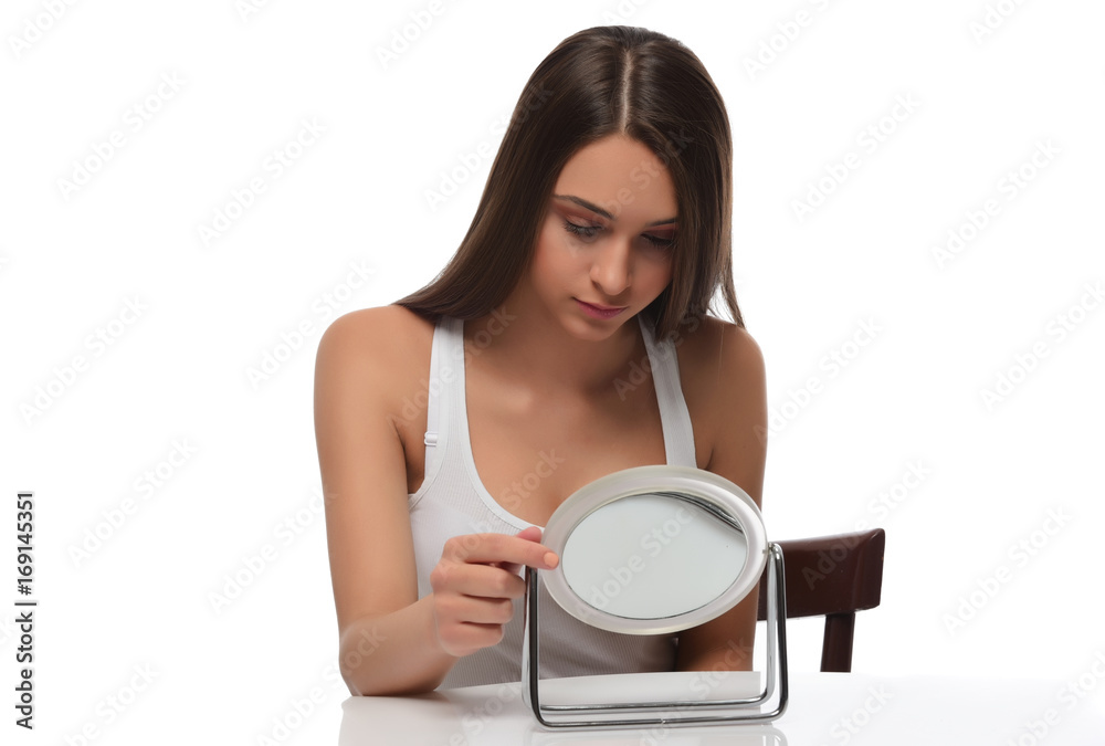 A young beautiful woman touching her hair. isolated A young beautiful woman touching her hair. isolated