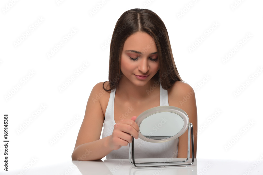 A young beautiful woman touching her hair. isolated A young beautiful woman touching her hair. isolated