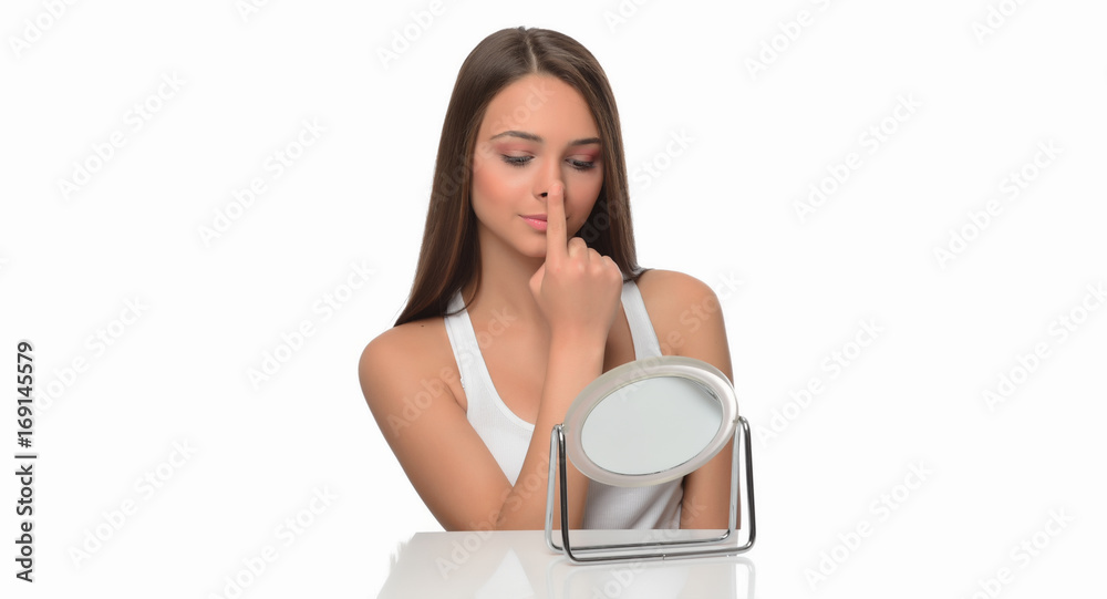 beautiful young female checking her facde skin beautiful young female checking her facde skin