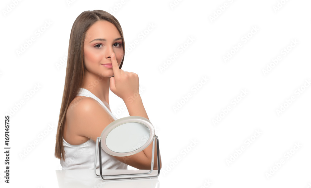 beautiful young female checking her facde skin beautiful young female checking her facde skin