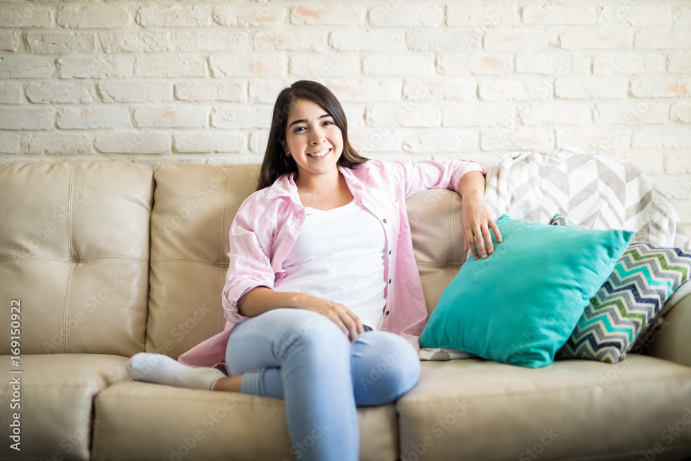 Young woman enjoying her cozy sofa Young woman enjoying her cozy sofa