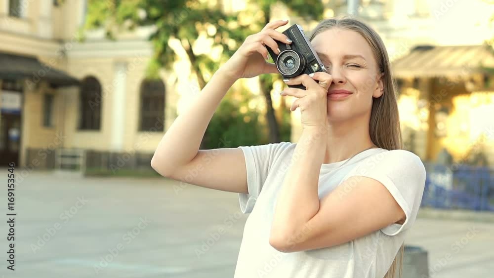 Pretty girl standing on the square in the city and doing photos on old camera, steadycam shot
Pretty girl standing on the square in the city and doing photos on old camera, steadycam shot
