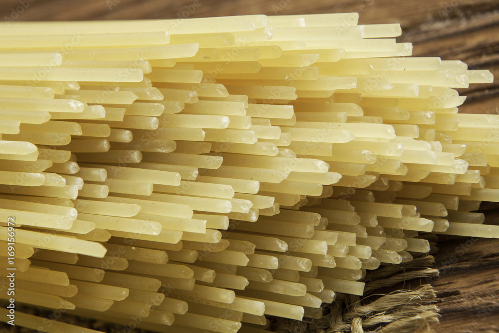Uncooked spaghetti on table Uncooked spaghetti on table