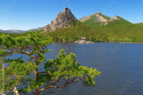 View of crag Okzhetpes and mysterious sphinx Zhumbaktas (puzzle-stone) on Burabai bay are located in Burabay National Nature Park in the Republic of Kazakhstan. Beautiful mountain landscape. photo