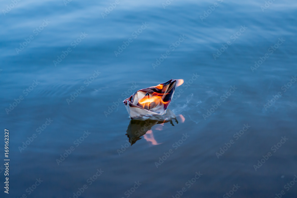 Fototapeta premium The paper boat burns