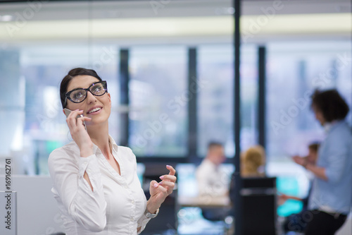 Elegant Woman Using Mobile Phone in startup office building