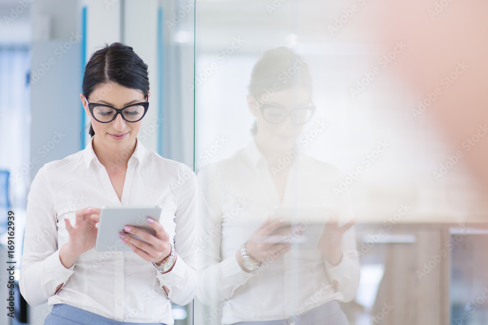 Business Woman Using Digital Tablet in front of startup Office Business Woman Using Digital Tablet in front of startup Office