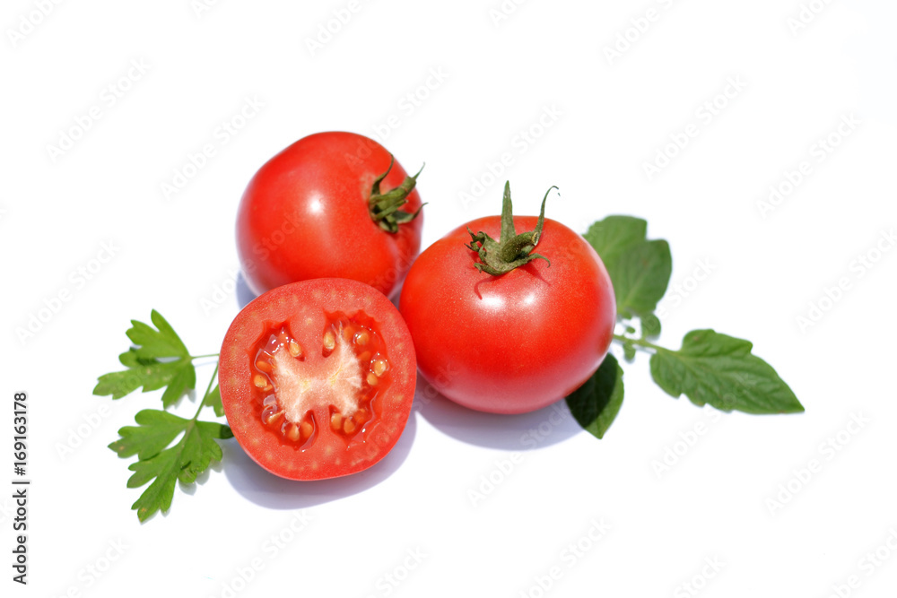 Tomatoes and greens on a white background. Tomatoes and greens on a white background.