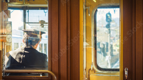 backside from train driver of Fujikyu classic train with wooden interior inside of train on autumn season