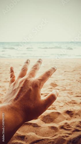 Man hand hope to reaching for the sea