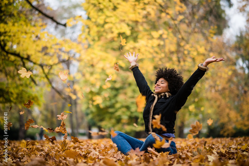 Woman united with nature in autumn