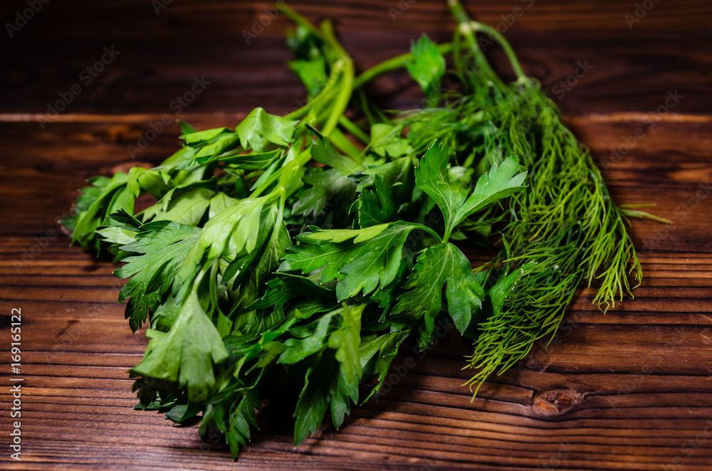 Bunch of parsley and dill on wooden table Bunch of parsley and dill on wooden table