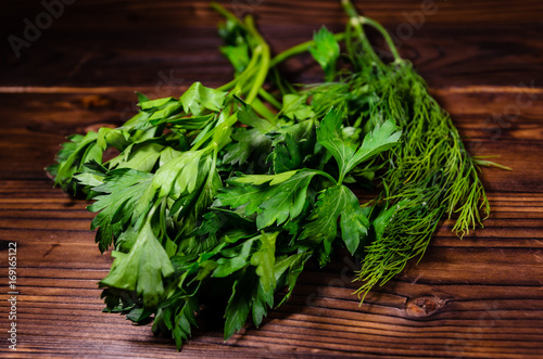 Bunch of parsley and dill on wooden table