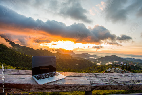 Freelancer office in mountain cafe. Online webinar everywhere via 4ginternet with mountain and sunrise background.