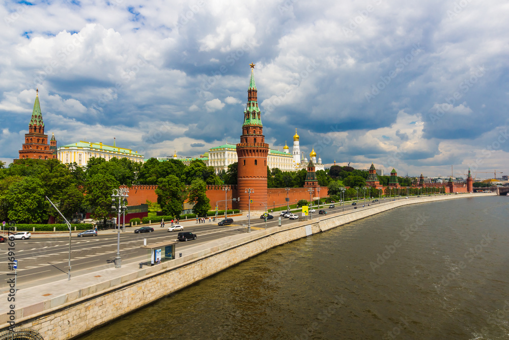 Kremlin and the Kremlin embankment in summer against the background of the cloudy sky. Thunderclouds