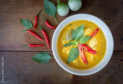 Green curry with chicken on dark wooden table top view. The popular food in Thailand.Thai food flat lay with copy space.