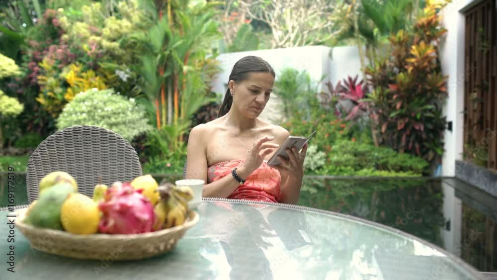 Attractive tanned woman looks absorbed while texting messages on smartphone, steadycam shot
Attractive tanned woman looks absorbed while texting messages on smartphone, steadycam shot