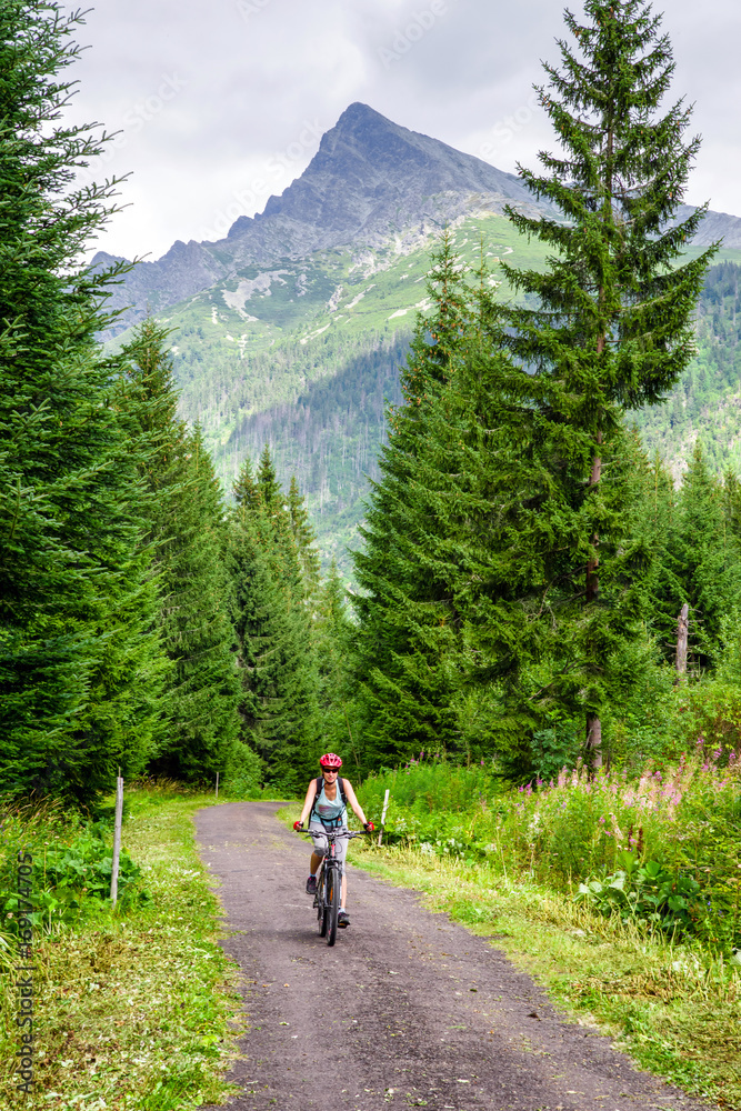 Woman on MTB bike in High Tatras mountains, Slovakia Woman on MTB bike in High Tatras mountains, Slovakia