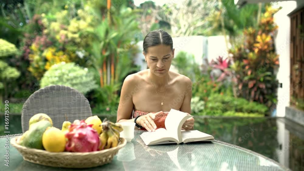 Asborbed woman turning pages in the book while looking for something, steadycam shot
Asborbed woman turning pages in the book while looking for something, steadycam shot