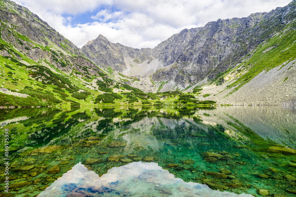 Naklejka premium Reflection in water at lake in High Tatras mountains, Slovakia