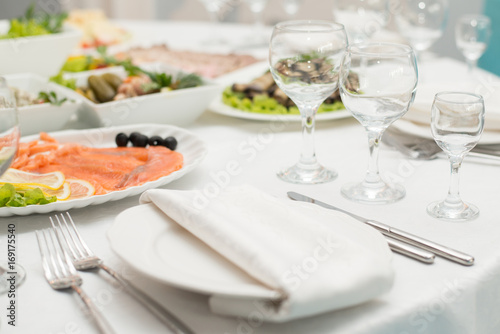 Served table in restaurant or cafe for a banquet, snacks and glasses for drinks