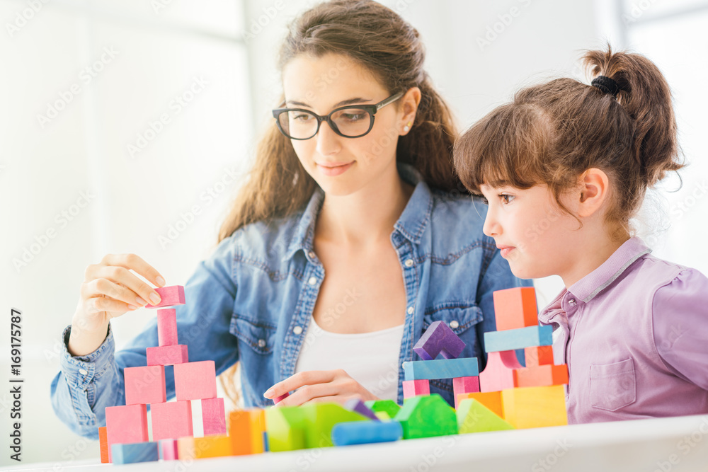 Fototapeta premium Mother and child playing together at home
