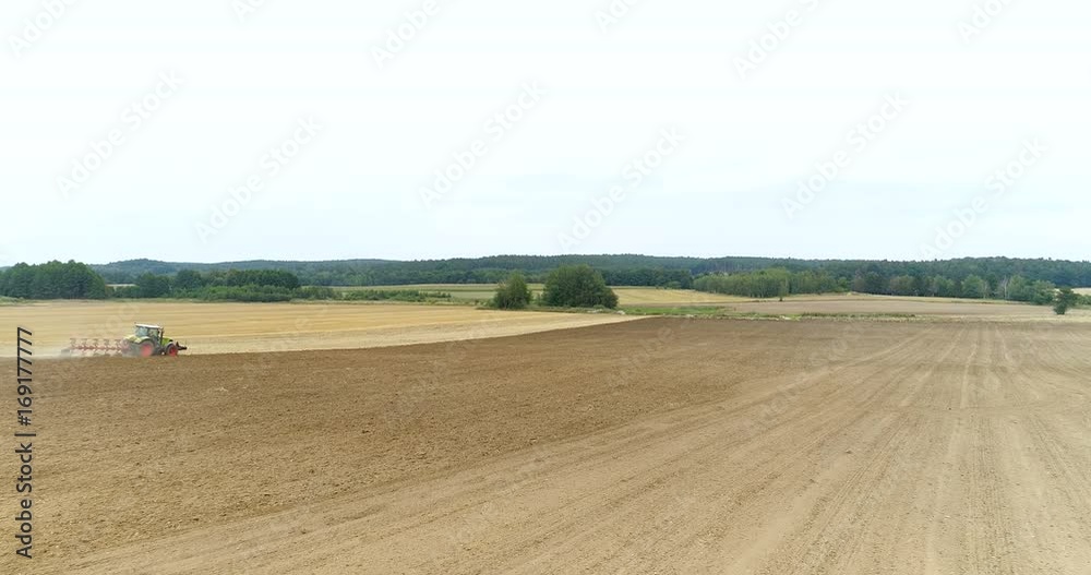AGRICULTURE - Wide shoot of tractor plowing field 4K AGRICULTURE - Wide shoot of tractor plowing field 4K