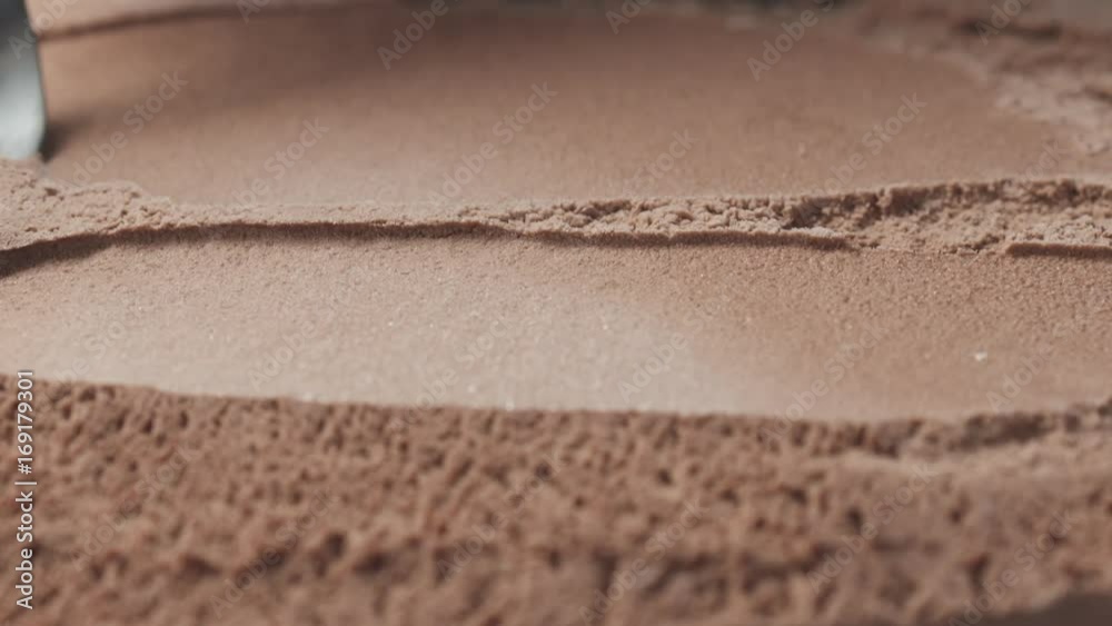 Slow motion of scooping chocolate ice cream with spoon Slow motion of scooping chocolate ice cream with spoon