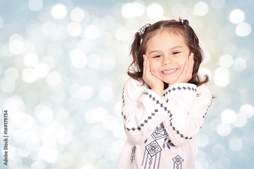 Happy little Muslim girl wearing Arabian clothes