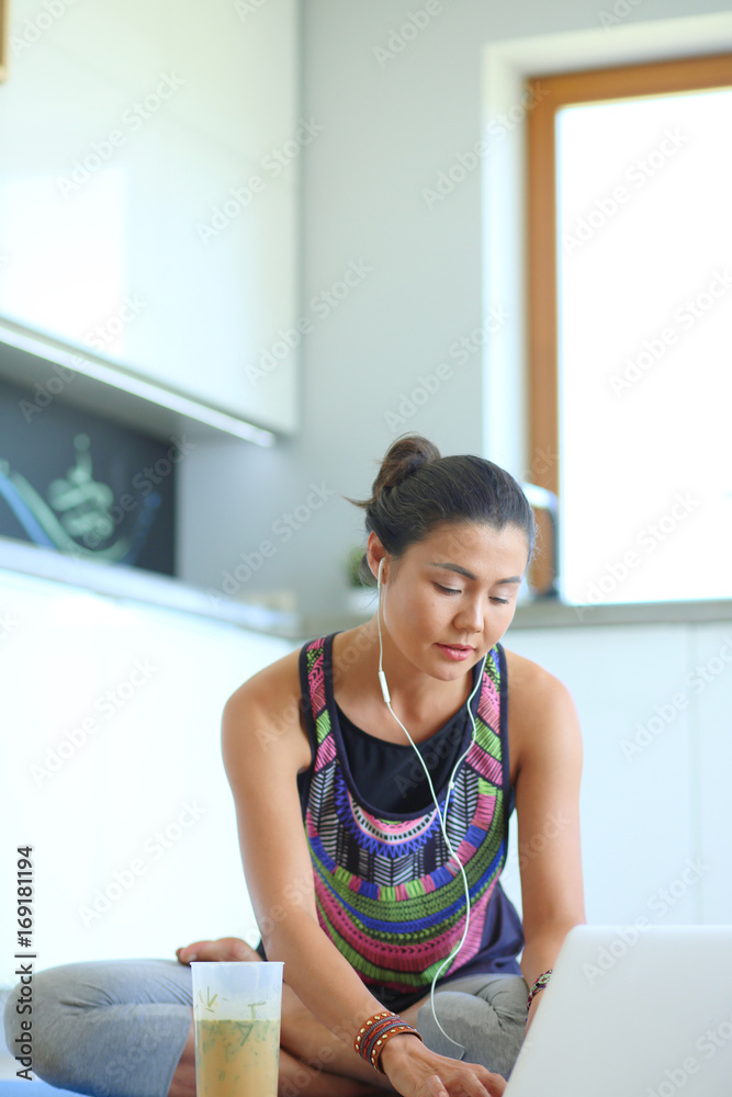 Sporty smiling woman using laptop in bright room. Woman. Lifestyle Sporty smiling woman using laptop in bright room. Woman. Lifestyle