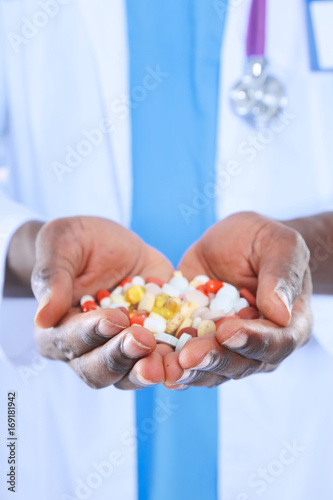 Pill in a hand isolated on white background. Doctor. Pill